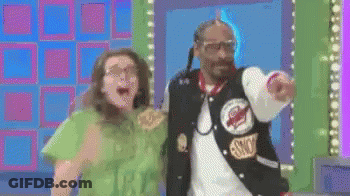 Snoop Dogg Is Standing Next To A Woman And Pointing GIF