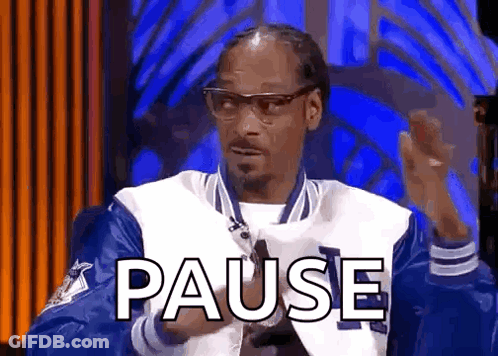 Snoop Dogg Is Wearing A Blue And White Jacket And Glasses While Sitting In Front Of A Blue Background . GIF