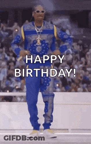 Snoop Dogg Is Wearing A Blue And Yellow Outfit And Dancing In Front Of A Crowd While Saying Happy Birthday . GIF