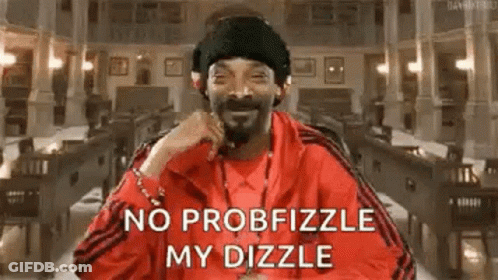 Snoop Dogg Is Wearing A Red Jacket And A Black Hat While Sitting In A Library . GIF
