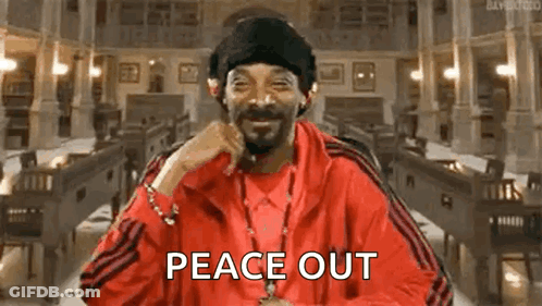 Snoop Dogg Is Wearing A Red Jacket And Hat And Smiling While Holding A Cigarette In His Mouth . GIF