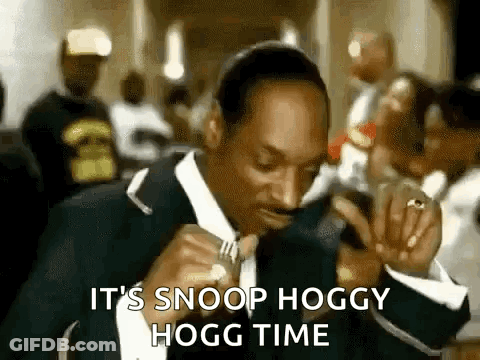 Snoop Dogg Is Wearing A Suit And Tie And Eating A Sandwich . GIF