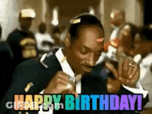 Snoop Dogg Is Wearing A Suit And Tie And Holding A Microphone And Says Happy Birthday . GIF