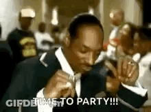 Snoop Dogg Is Wearing A Suit And Tie And Saying `` Time To Party !!! '' . GIF