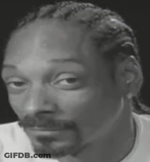 Snoop Dogg Is Wearing A White Shirt And Making A Funny Face . GIF