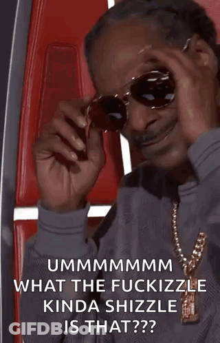 Snoop Dogg Is Wearing Sunglasses And A Necklace While Sitting In A Red Chair . GIF