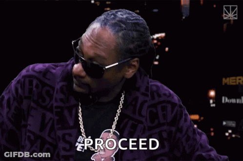 Snoop Dogg Is Wearing Sunglasses And A Purple Jacket With The Word Proceed Written On It GIF