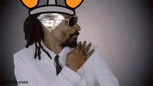 Snoop Dogg Wearing A Crown And Sunglasses With A Diamond In His Eye GIF