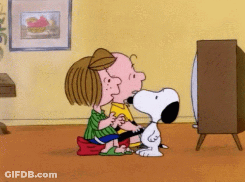 Snoopy And Charlie Brown Are Sitting On The Floor Watching A Television . GIF