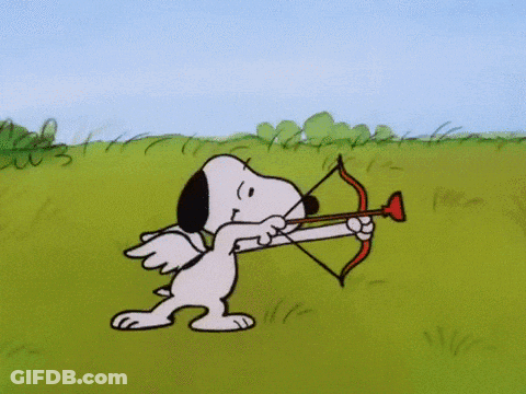 Snoopy Holding A Bow And Arrow In A Field GIF