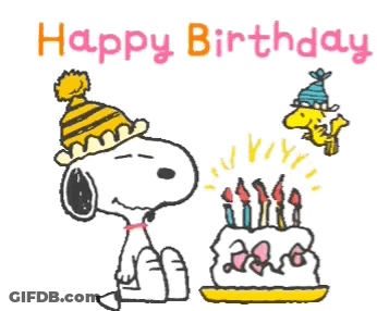 Snoopy Is Blowing Out Candles On A Birthday Cake GIF