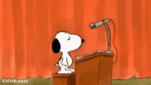 Snoopy Is Giving A Speech In Front Of A Microphone . GIF