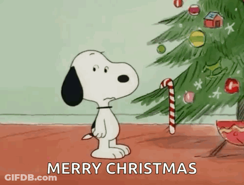 Snoopy Is Holding A Candy Cane In Front Of A Christmas Tree And Says Merry Christmas . GIF
