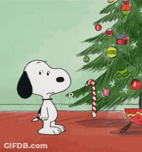 Snoopy Is Looking At A Christmas Tree With A Candy Cane . GIF