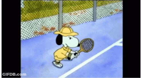 Snoopy Is Playing Tennis On A Tennis Court GIF