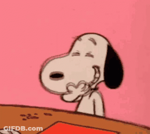 Snoopy Is Sitting At A Table With His Eyes Closed And His Hand On His Face . GIF