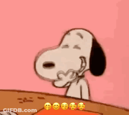 Snoopy Is Sitting At A Table With His Eyes Closed And Making A Funny Face . GIF