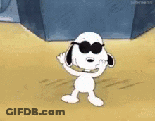 Snoopy Is Wearing Sunglasses And Waving His Hand While Standing On The Beach . GIF
