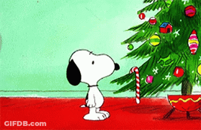 Snoopy Standing Next To Christmas Tree Holding Candy Cane GIF