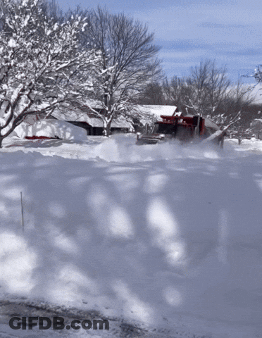 Snow Plow Driving Through Snowy Driveway GIF