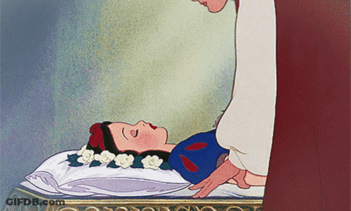 Snow White Laying On Bed With Flowers In Hair GIF