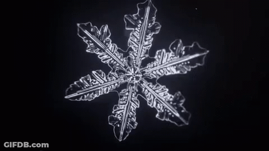 Snowflake Rotating In The Dark GIF