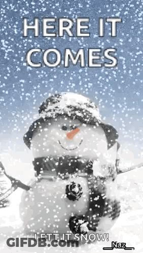 Snowman In Hat And Scarf Saying Here It Comes Let It Snow GIF