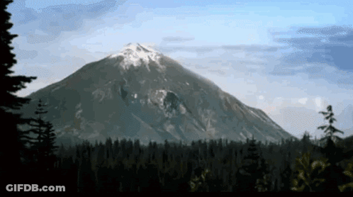 Snowy Mountain Surrounded By Trees GIF