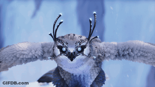 Snowy Owl With Glowing Eyes Flying In Snow GIF