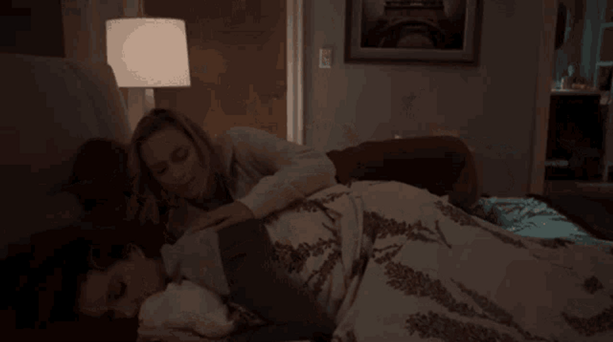 Snuggling Couple In The Dark Room GIF
