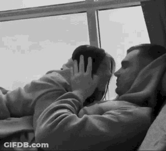 Snuggling Couple Kissing GIF