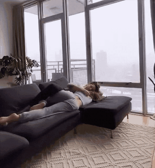 Snuggling Couple On The Sofa GIF