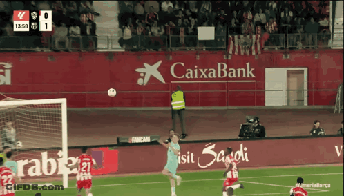 Soccer Game In Front Of Caixabank Banner GIF