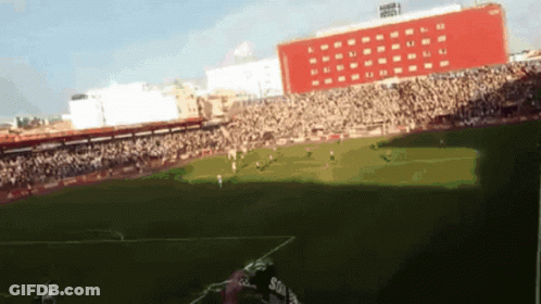 Soccer Game In Stadium With Red Building GIF