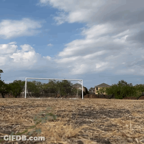 Soccer Goal In Dry Field With House GIF