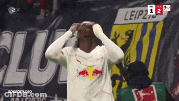 Soccer Player Celebrates Goal In Front Of Leipzig Banner GIF