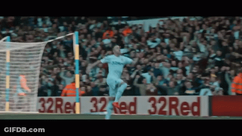 Soccer Player Celebrating Goal In Front Of 32 Red Sign GIF