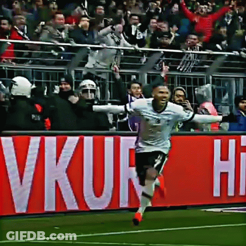 Soccer Player Celebrating Goal In Front Of VKUR Sign GIF