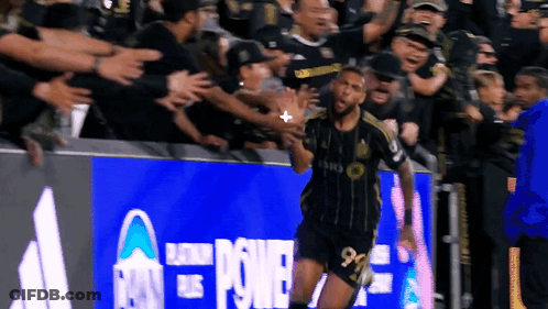 Soccer Player Celebrating Goal Under Power Banner GIF