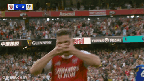 Soccer Player Covering Face In Red Jersey GIF