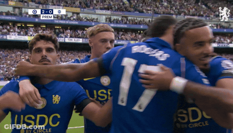 Soccer Player Covering Mouth In Front Of Modelo Scoreboard GIF