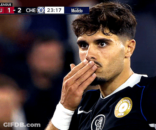 Soccer Player Covering Mouth In Front Of Modelo Scoreboard GIF