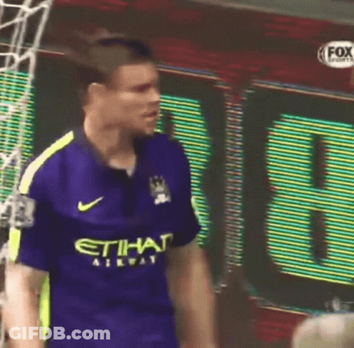 Soccer Player Dribbling Ball Near Fone Sign GIF