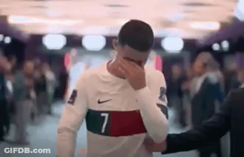 Soccer Player Facepalms, Man In Suit Holds Shoulder GIF