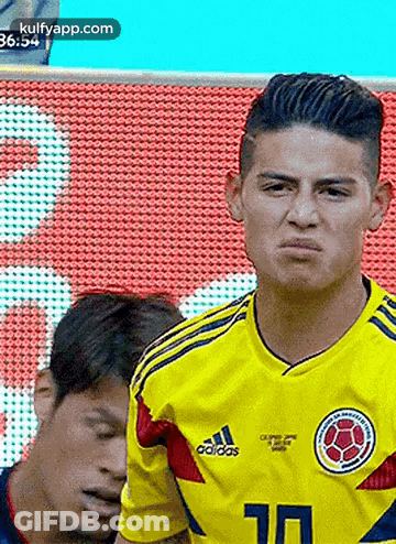 Soccer Player Funny Face Next To Another Player GIF