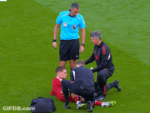 Soccer Player Helped By Referee In Puma Shirt GIF
