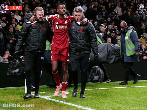 Soccer Player Helped Off By Standard Chartered Man GIF