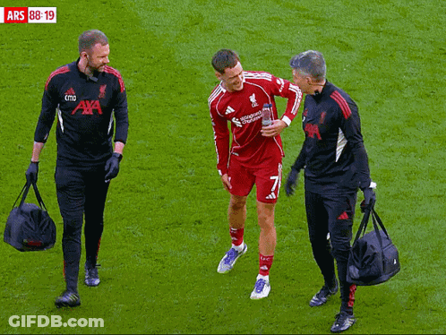 Soccer Player Helped Off Field By Men In Aya Shirts GIF