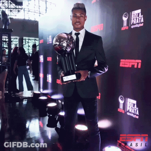 Soccer Player Holding Trophy And Box GIF