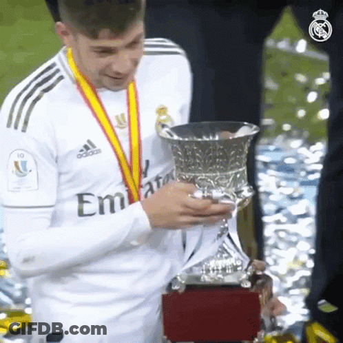 Soccer Player Holding Trophy In Emirates Shirt GIF